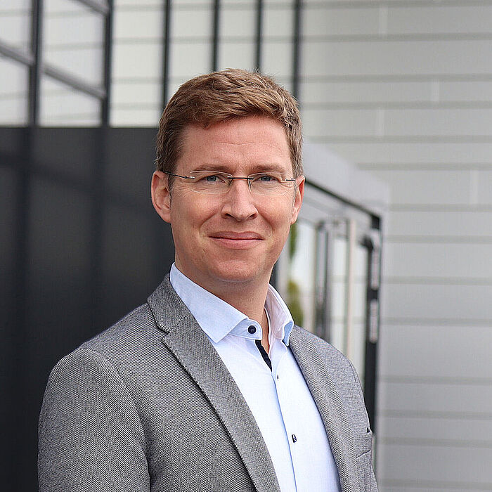 Portrait of a man in front of a building