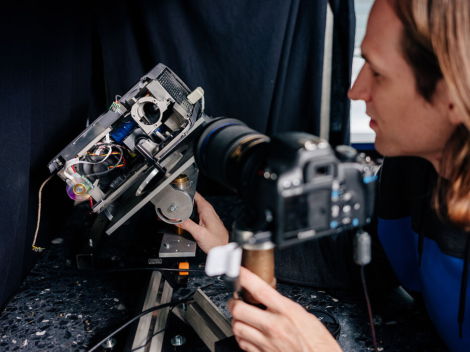 A young man tinkers with a technical device.